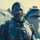 Idris Elba, in costume as Bloodsport, stands with King Shark in The Suicide Squad.
